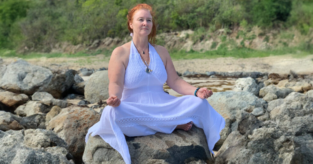 Deanna Meditating on a Rock